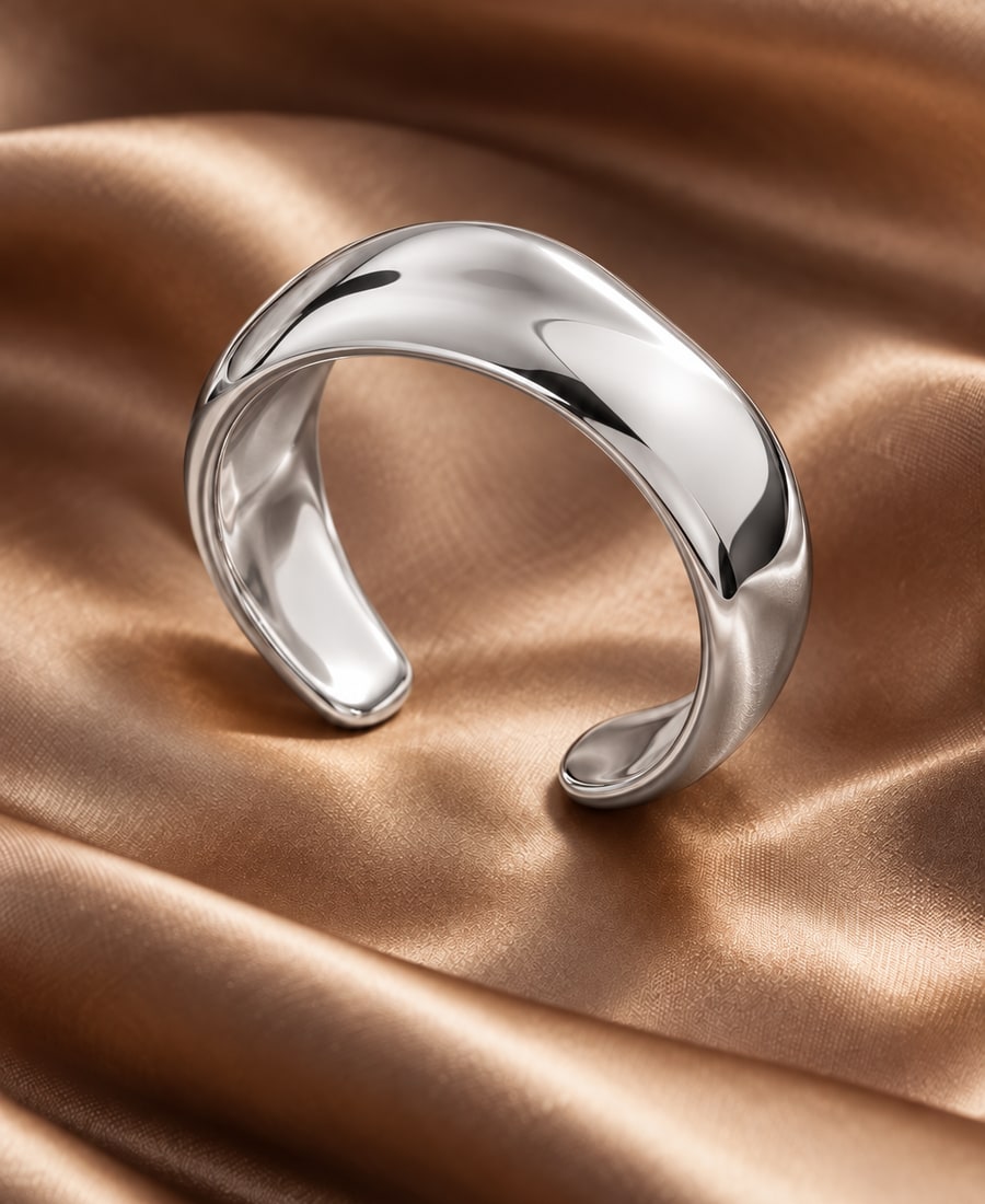 Sable Cuff — A polished open cuff with a sculptural, weighted profile and no stones.